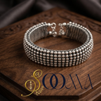 Close up shot of Sooma brand designer minimalist silver open bangle showing the clean architectural finish on a premium textured background