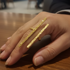 Hand wearing a Elegant long finger ring, modern office wear.