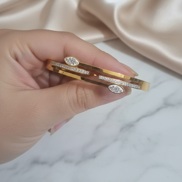 Hand holding a Designer Gold AD Bracelet 