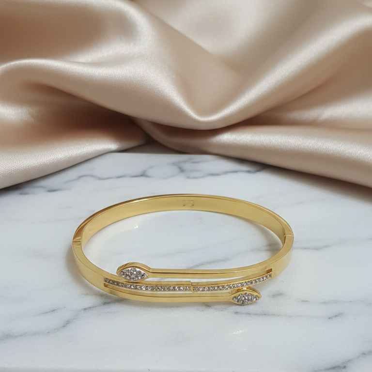 Designer Gold AD Bracelet on a marble surface