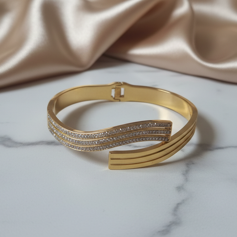 Close-up of a gold-plated bracelet with a secure clasp, showcasing its radiant finish and sleek design.