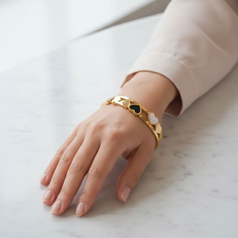 Elegant heart bracelet on a woman's wrist, suitable for professional attire.