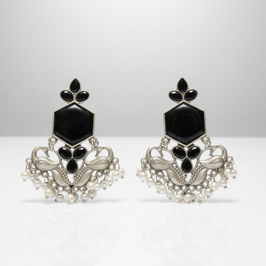 Oxidised silver-tone ethnic earrings with detailed craftsmanship.
