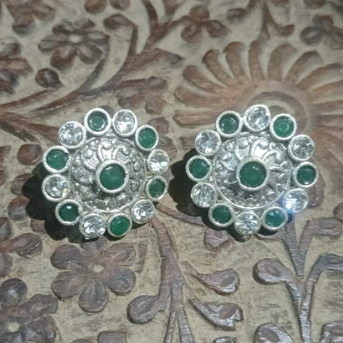 Pair of elegant silver oxidised stud earrings with green and clear kundan stones 