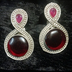 Designer pair of silver oxidised deep red stud earrings .