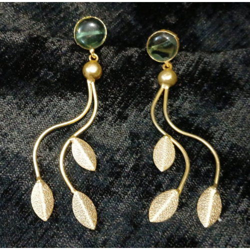 Unique design long dangle earrings with green stone and gold leaf designs .