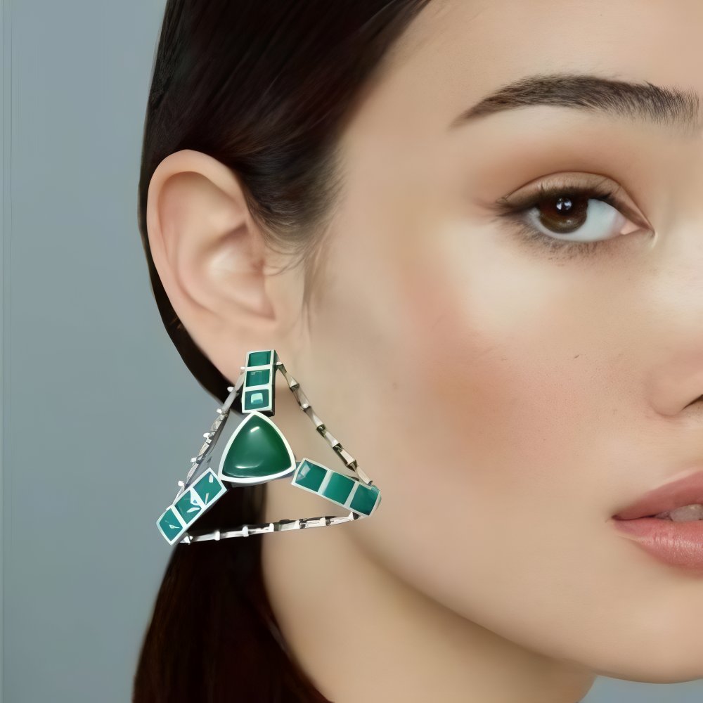 Close-up of a woman wearing a green triangle silver oxidised earrings.