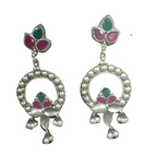 A drop & dangle ornate silver oxidised earring with green &  pink kundan stones .