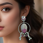 Close-up of a woman wearing a decorative earring with pink gemstones.