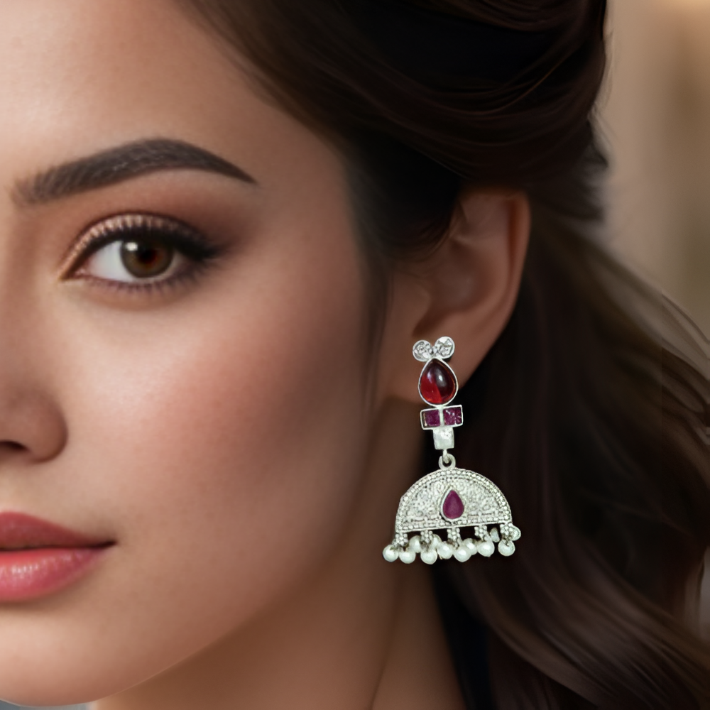 Close-up of a pretty woman wearing a dangle earring with stones.
