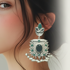 A woman wearing silver oxidised traditional earrings with black & green stones
