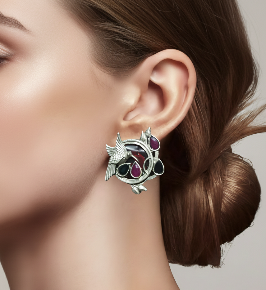 Close up of a lady wearing silver oxidised earrings