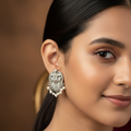 Close up of a model wearing peacock design stud earrings