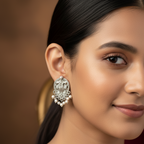 Close up of a model wearing peacock design stud earrings
